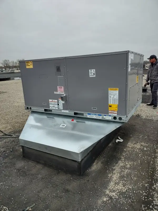 Man next to A/C Unit on Roof